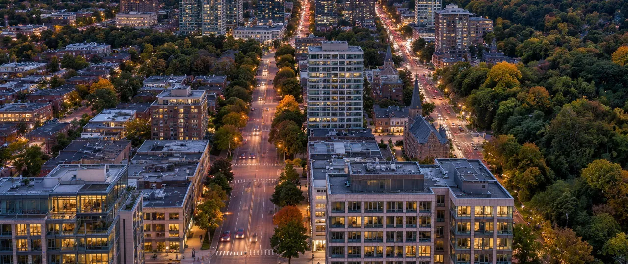 Dusk view north from a Yorkville penthouse over Avenue Road toward St. Clair, Forest Hill and Summerhill